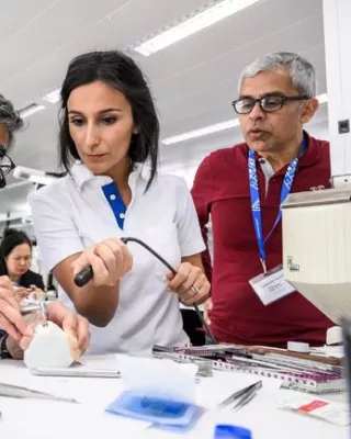 Dentists practicing with a dental drill