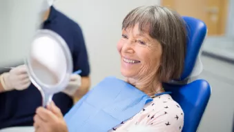 Nobel Biocare All-on-4 patient looks in the mirror