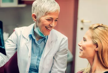 Nobel Biocare dentist speaking with a patient